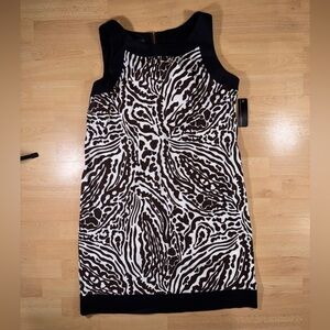 Elegant Brown and White Patterned Dress with Black Trim